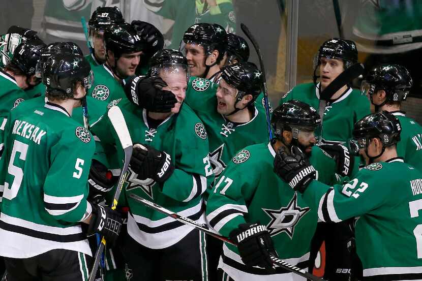 Dallas Stars players including Esa Lindell (23), who scored the game-winning goal against...