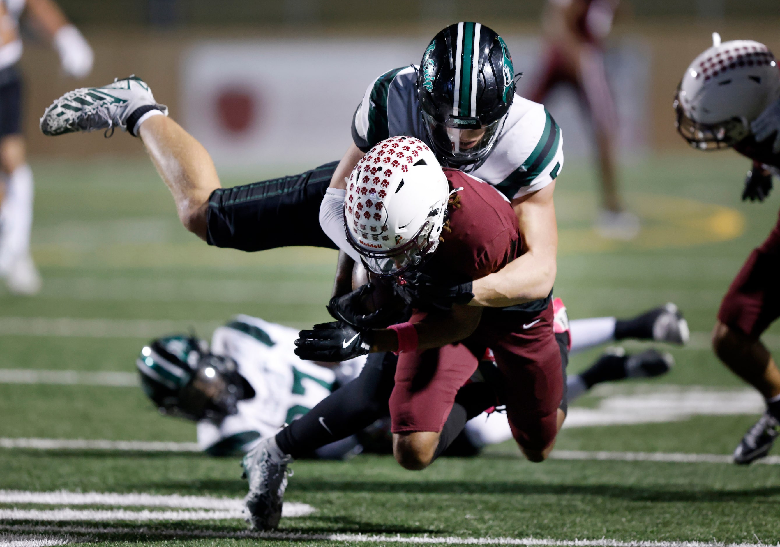 Prosper High’s Colin Freeman (5) tackles Plano High wide receiver DJ Hamilton (2) during the...