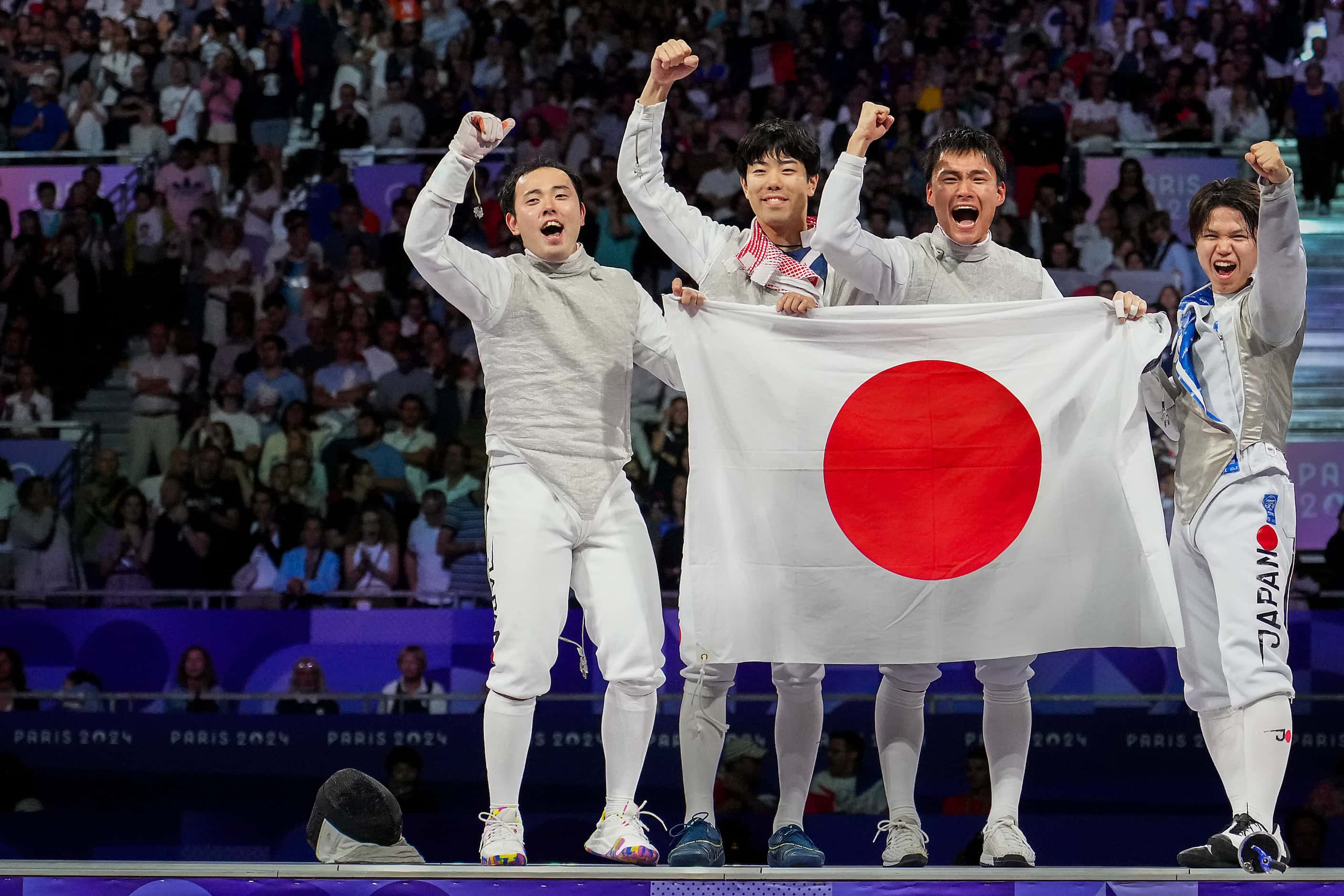 Team Japan celebrates after a victory over Italy in the men’s foil team gold medal match at...
