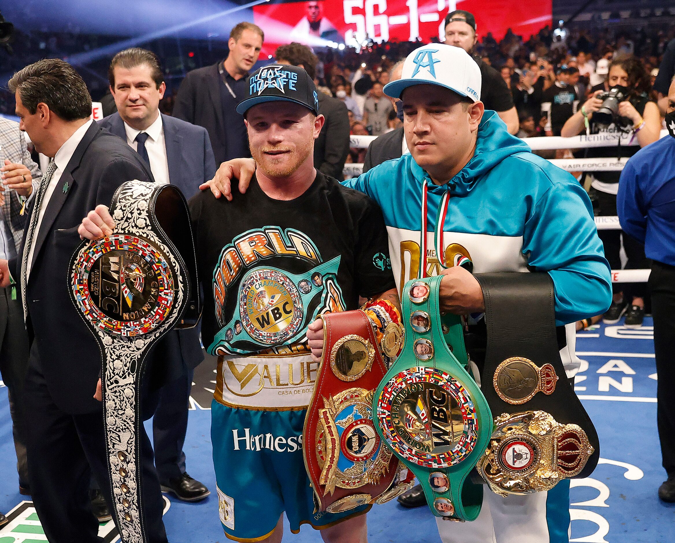 Boxers Canelo Alvarez (left) celebrates with his new WBC belt after defeating Billy Joe...