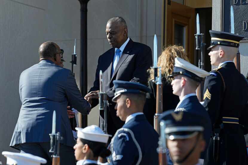 Defense Secretary Lloyd Austin, right, greets Kenya's Defense Minister Aden Duale, left,...