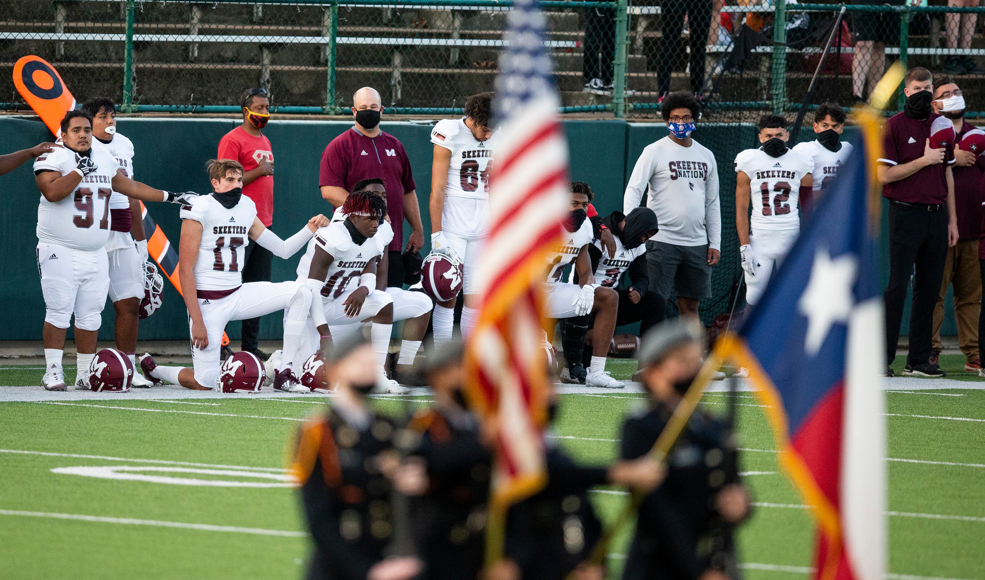 Mesquite players kneel during the National Anthem to bring attention to social justice...