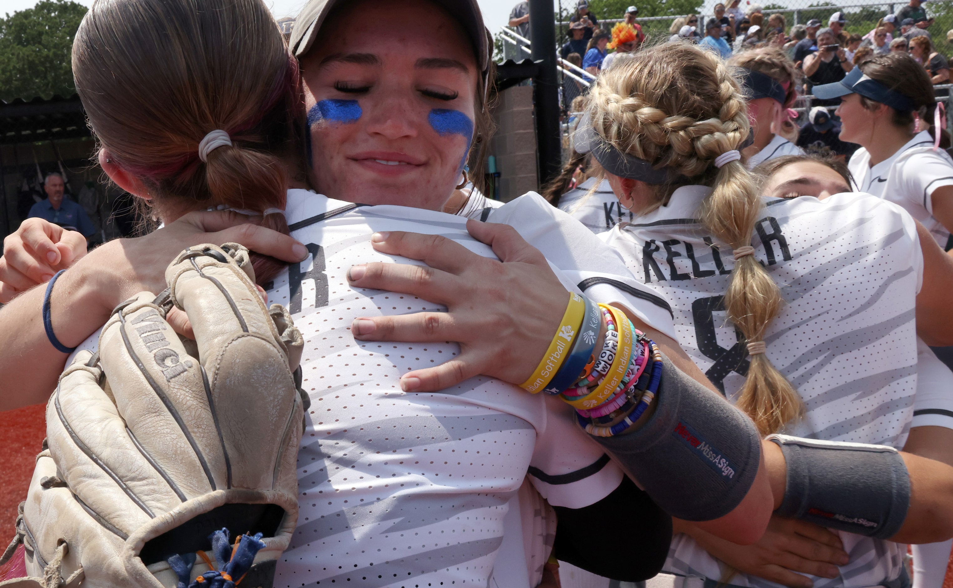 Keller players hug as they celebrate their 5-1 victory over Flower Mound in the deciding...