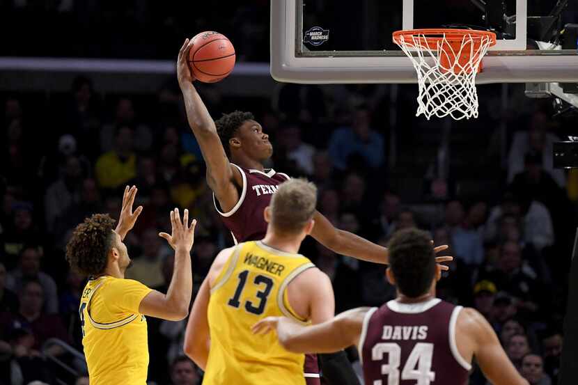 Texas A&M's  Robert Williams rises for a dunk in the first half against the Michigan...