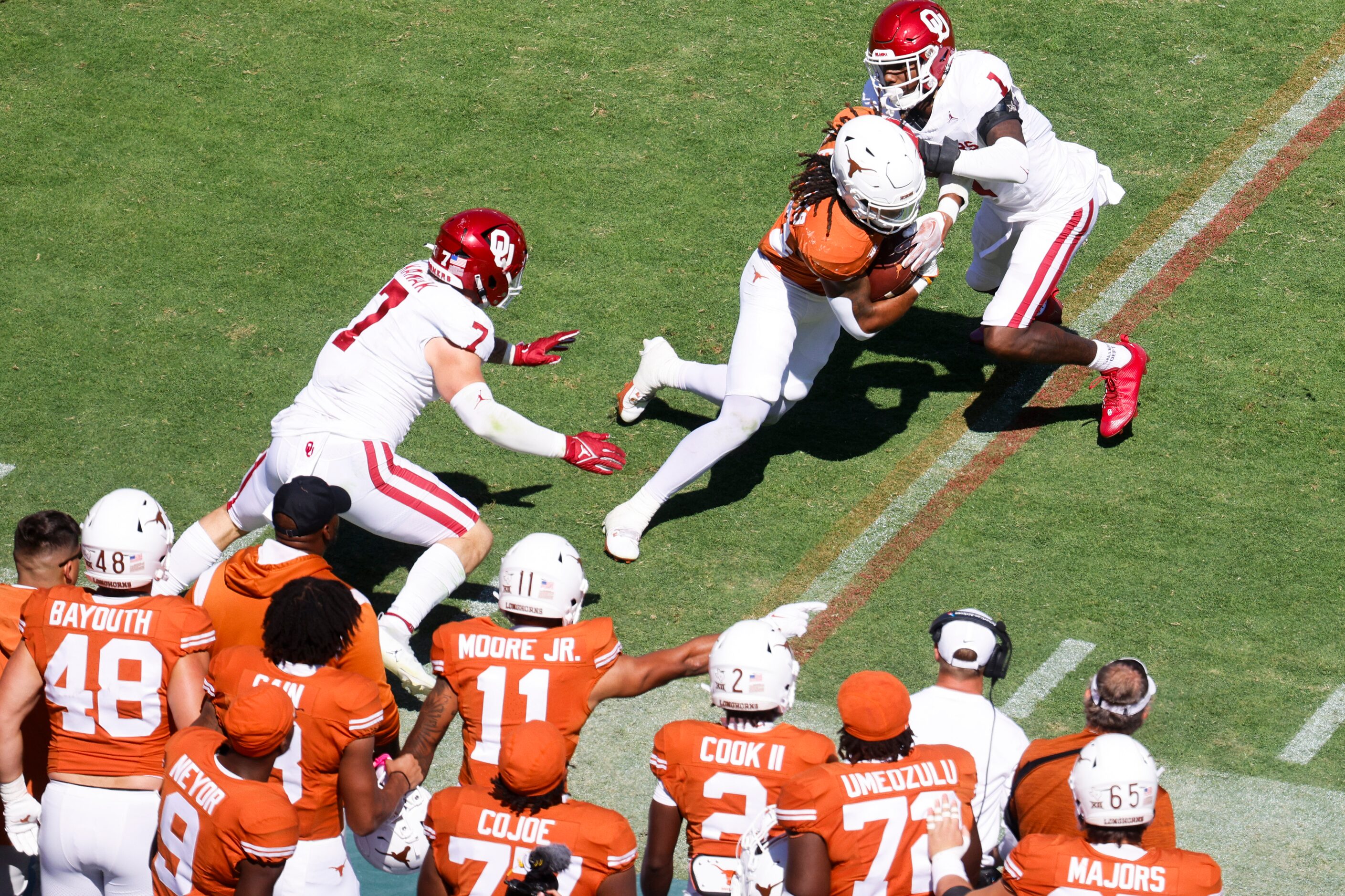 Oklahoma linebacker Jaren Kanak (left) and Oklahoma linebacker Dasan McCullough (13) tackles...