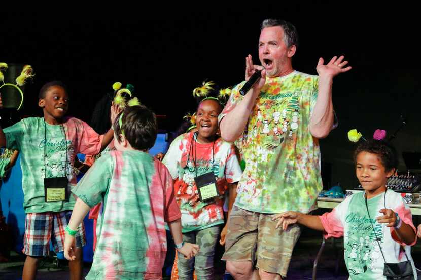 Dallas children's singer and songwriter Eddie Coker performs Friday with campers in a...