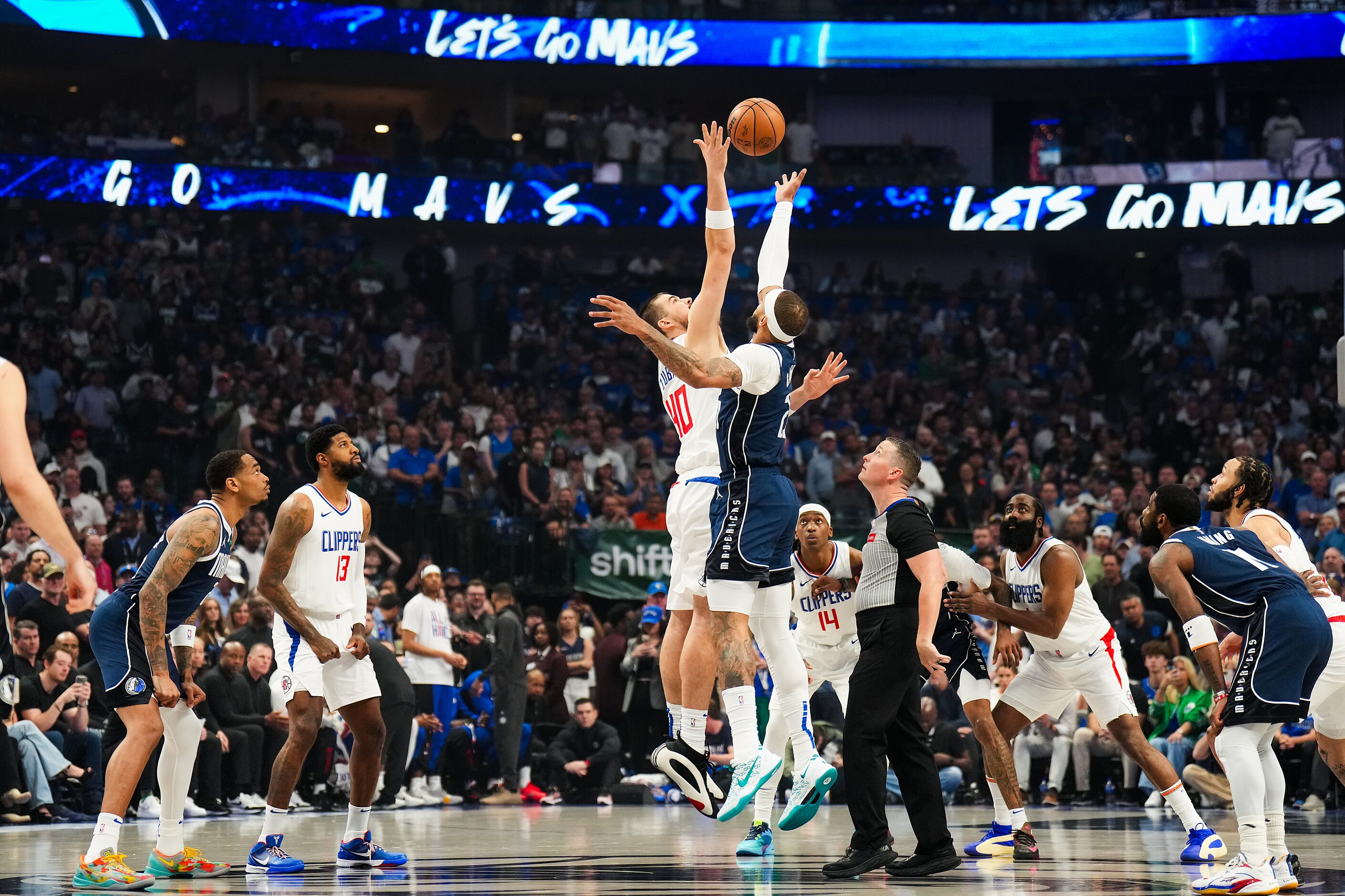 Dallas Mavericks center Dereck Lively II (2) goes up for the opening tipoff against LA...