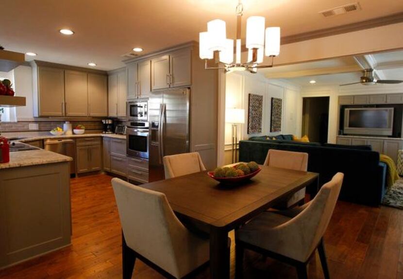 
Two walls were removed to create an open space encompassing the kitchen, dining area and...