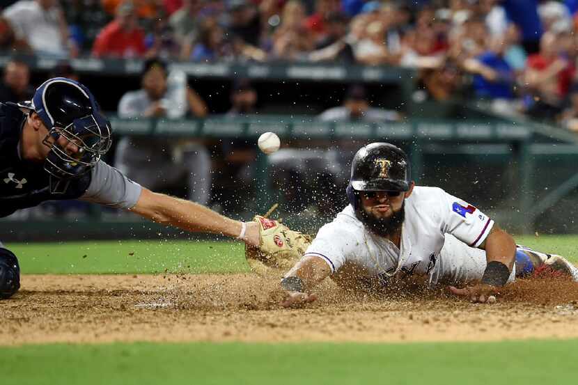 Texas Rangers second baseman Rougned Odor (12) steals home ahead of the tag of Detroit...