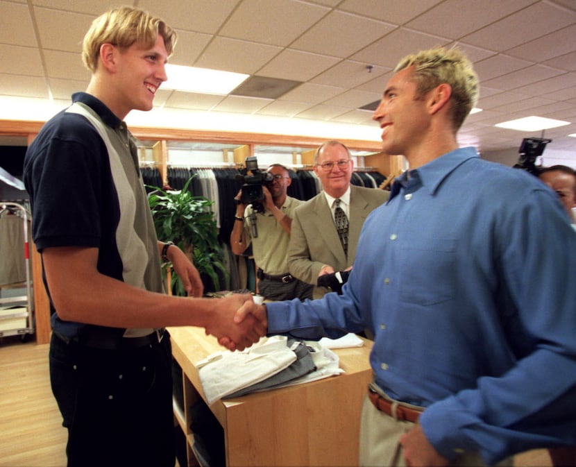 Mavericks' first-round draft choice Dirk Nowitzki, left,  gets a handshake during his visit...