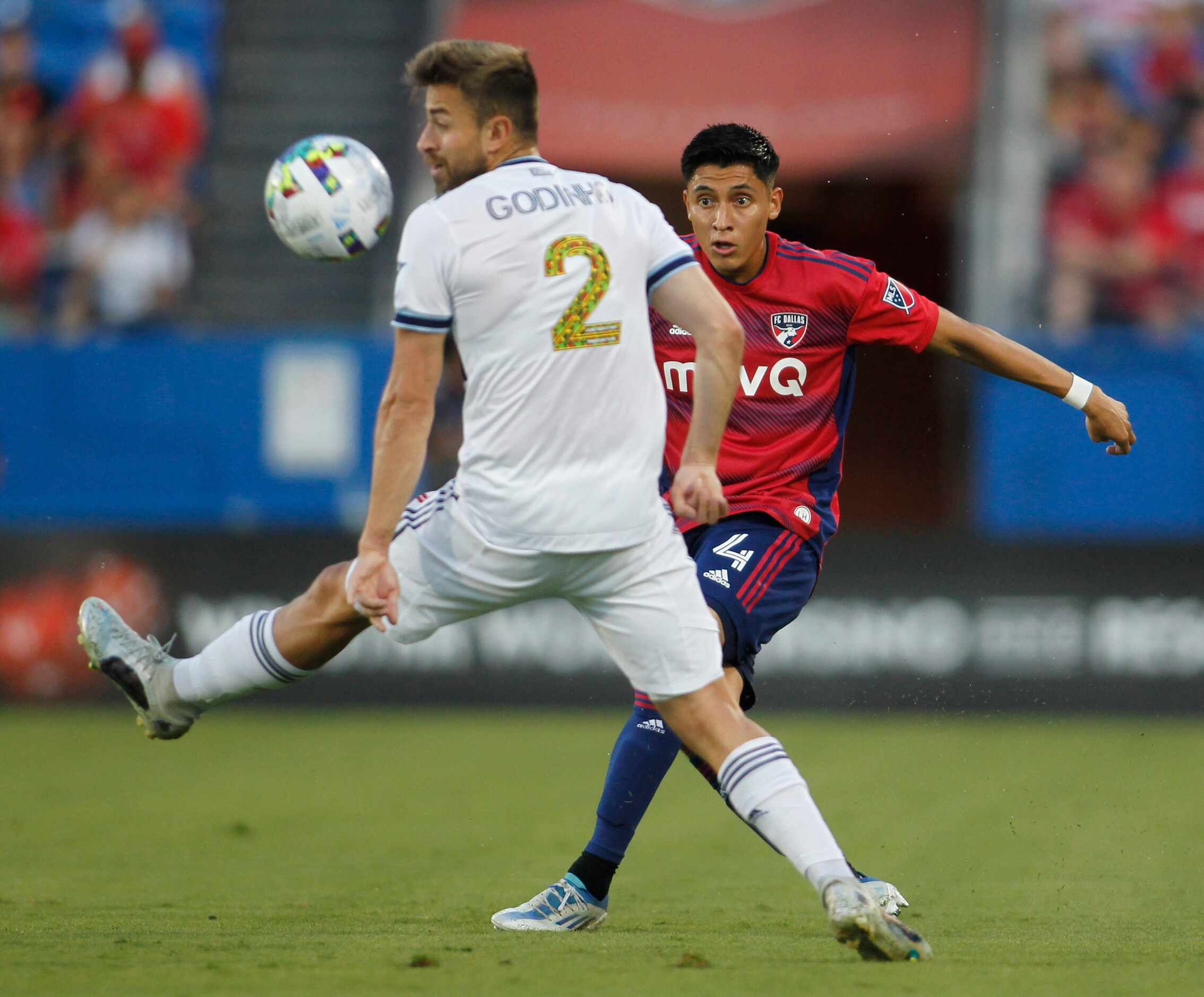 FC Dallas defenseman Marco Farfan (4) eyes the ball after kicking it clear of the defense of...
