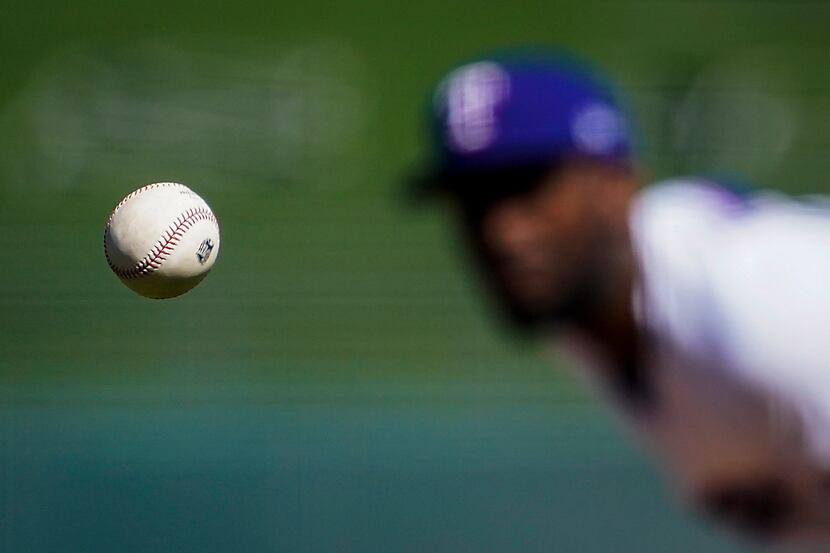 Texas Rangers pitcher Taylor Hearn pitches during the first inning of a spring training game...