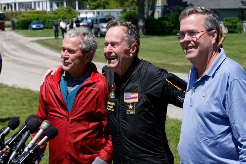  In this June 12, 2009, file photo. former President George H. W. Bush, center, is joined by...