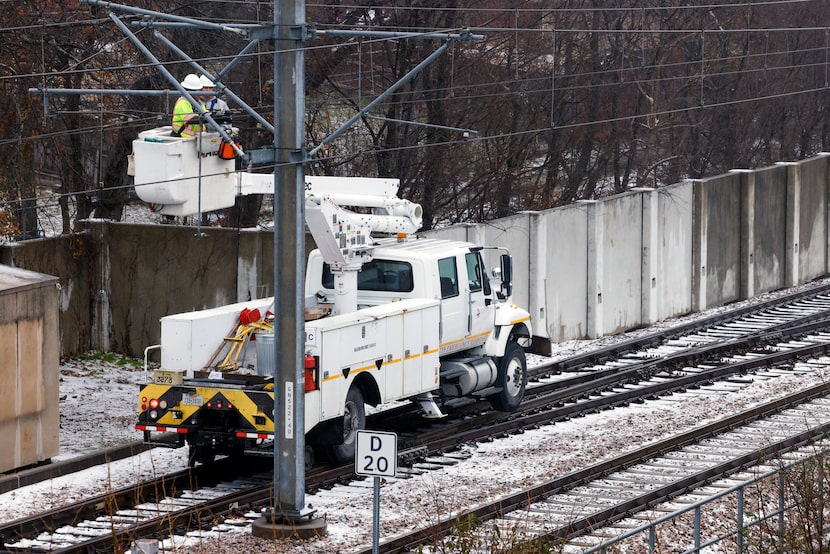 Dallas Area Rapid Transit employees service the Blue light rail line near White Rock Station...