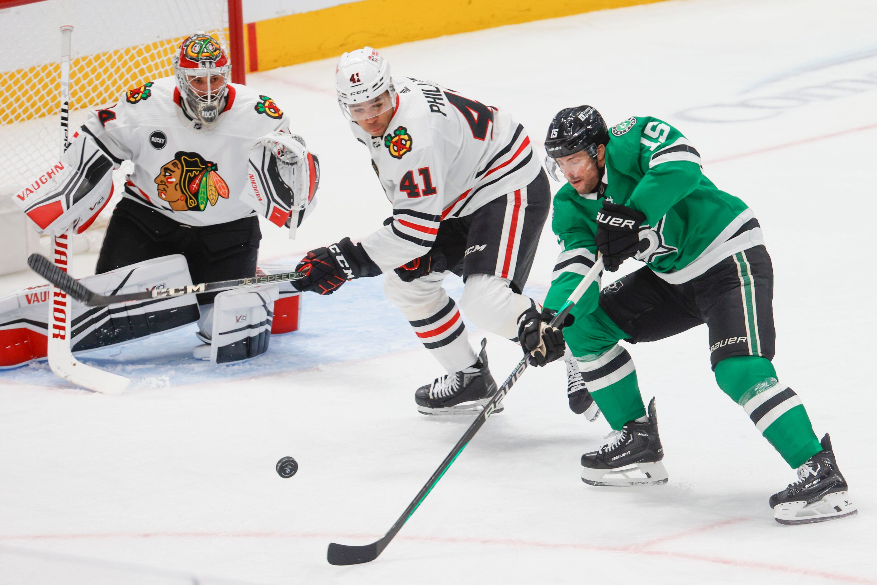 Chicago Blackhawks goaltender Petr Mrazek (left) watches as defenseman Isaak Phillips (41)...