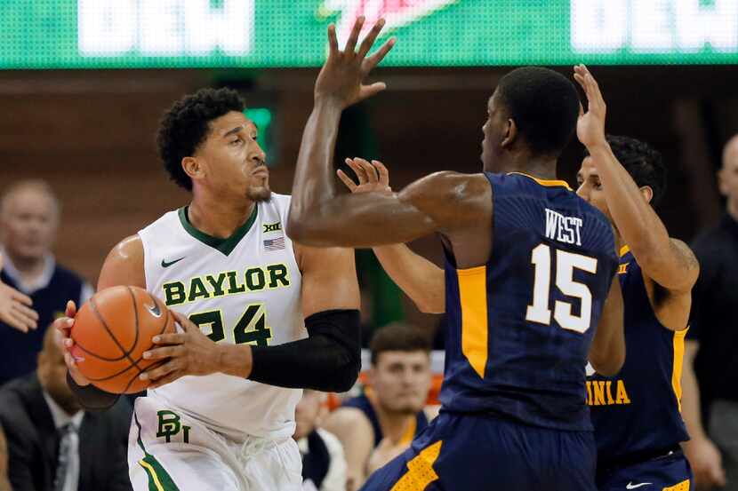 Baylor's Ishmail Wainright (24) attempts to pass the ball as West Virginia's Lamont West...