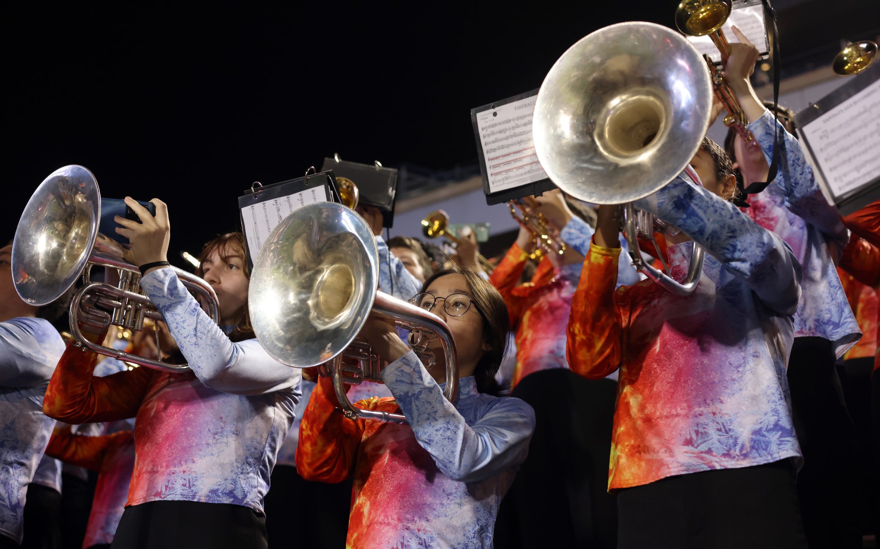 Allen High School marching band members perform from the stands during first quarter action...