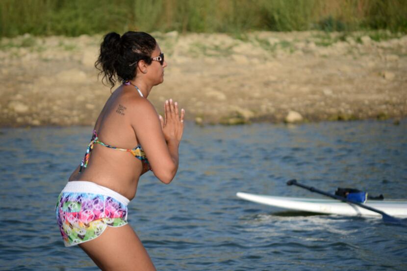 Natalie West of Highland Village does paddleboard yoga on Lewisville Lake. Paddleboard yoga...