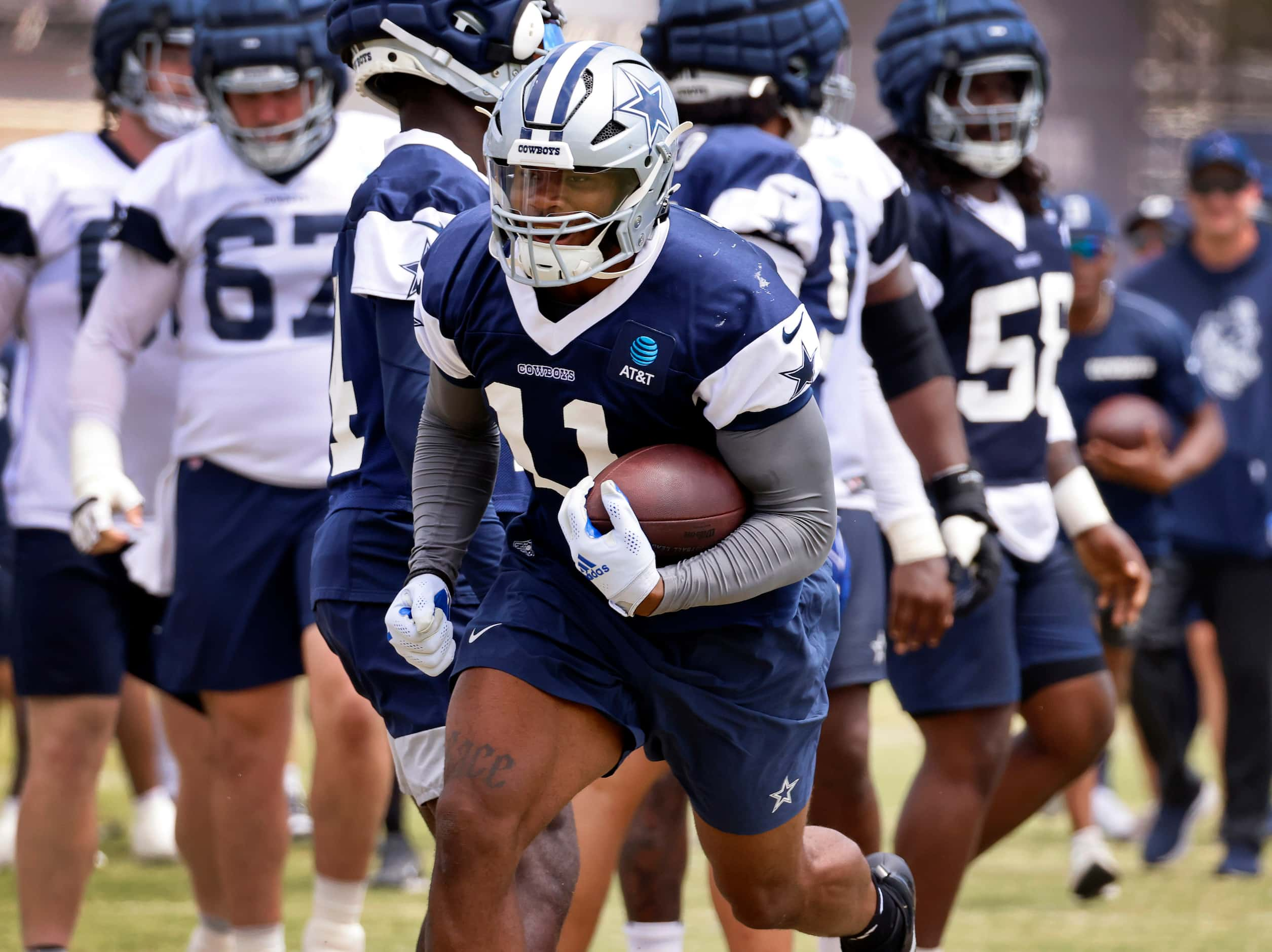 Dallas Cowboys linebacker Micah Parsons (11) smiles as he breaks away on a running play for...