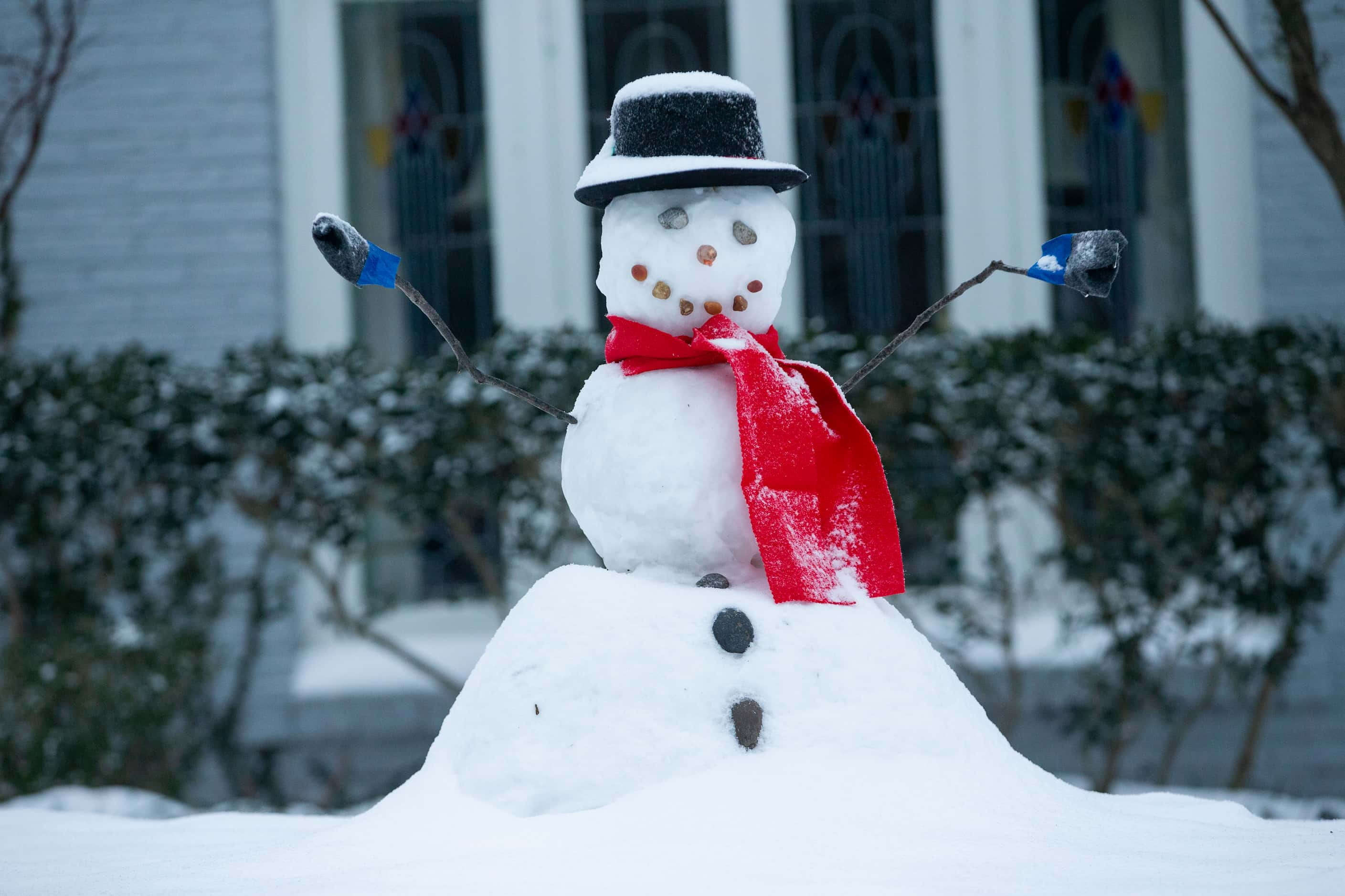 A snowman in Lower Greenville sits with fresh snow on its head in Dallas on Wednesday, Feb....