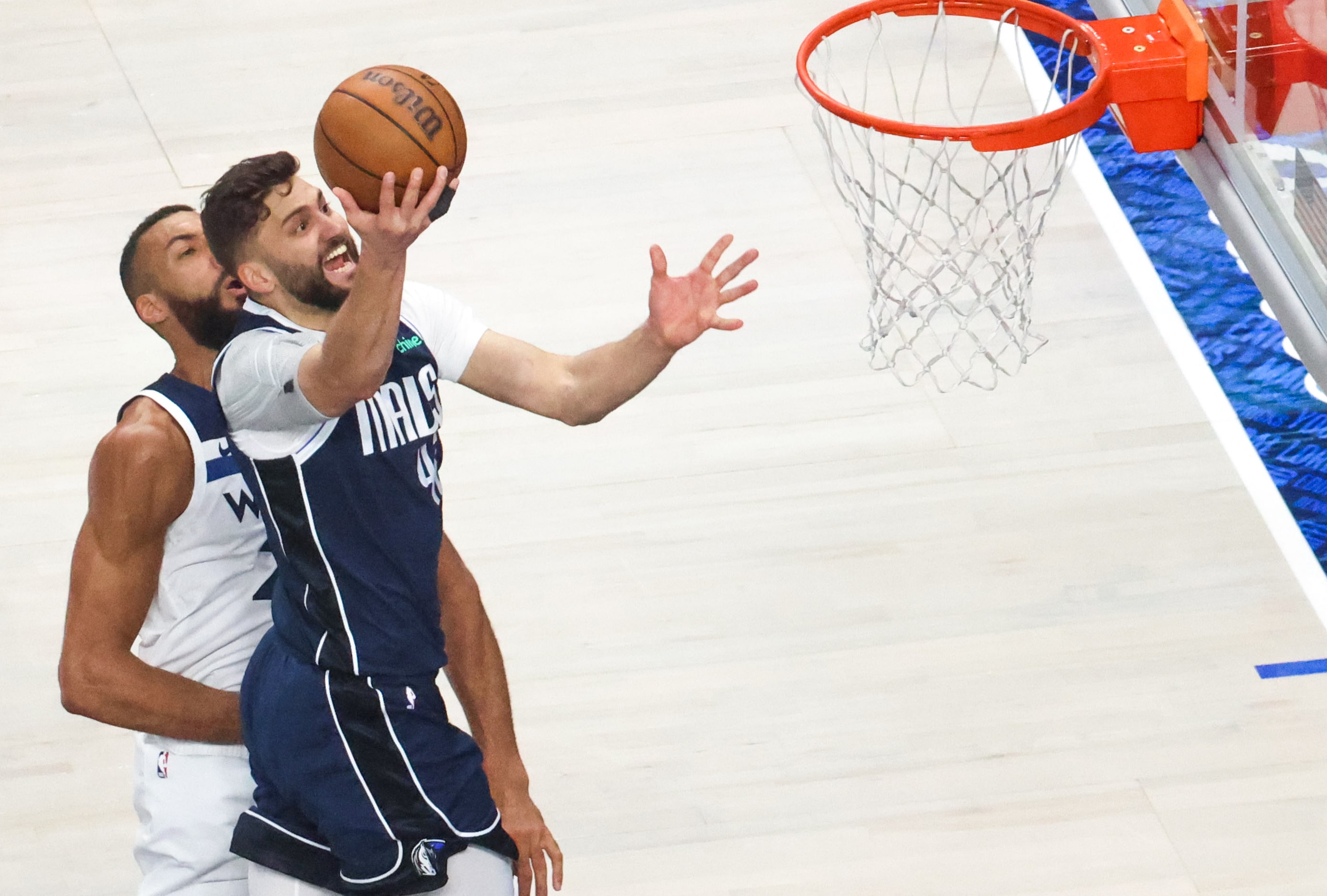 Dallas Mavericks forward Maxi Kleber (front) drives to the basket past Minnesota...