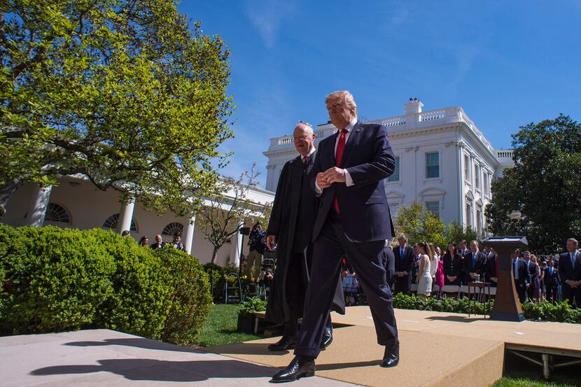 President Donald Trump (right) and Justice Anthony Kennedy make their way back to the Oval...