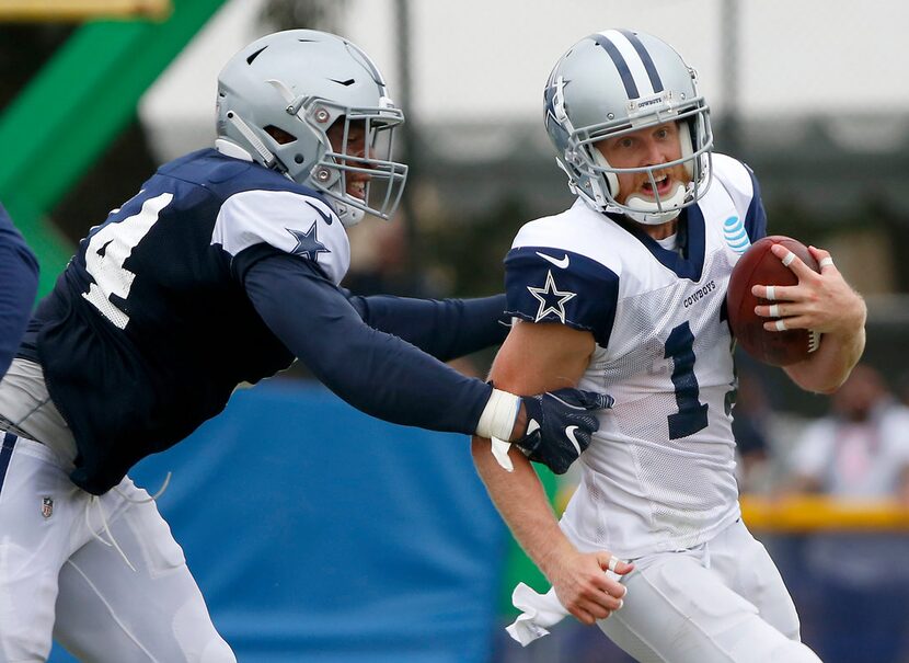 Cowboys wide receiver Cole Beasley (right) is tackled by defensive end Dorance Armstrong...