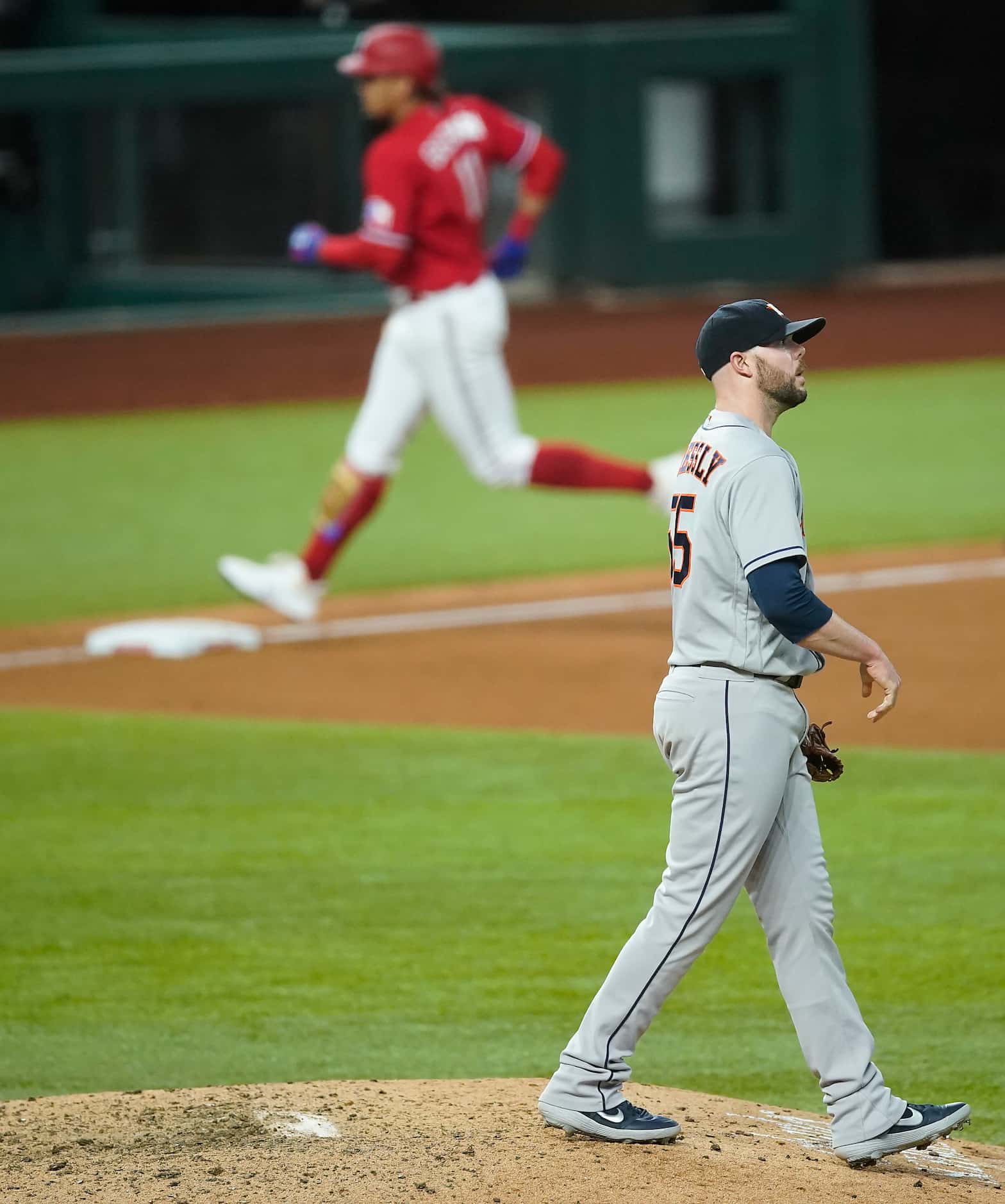 Houston Astros pitcher Ryan Pressly reacts as Texas Rangers first baseman Ronald Guzman...