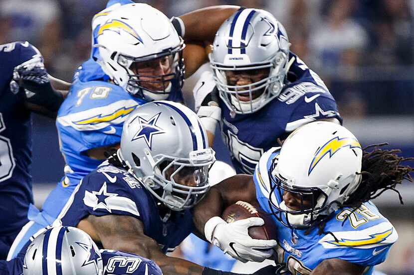 Los Angeles Chargers running back Melvin Gordon (28) is brought down by Dallas Cowboys...