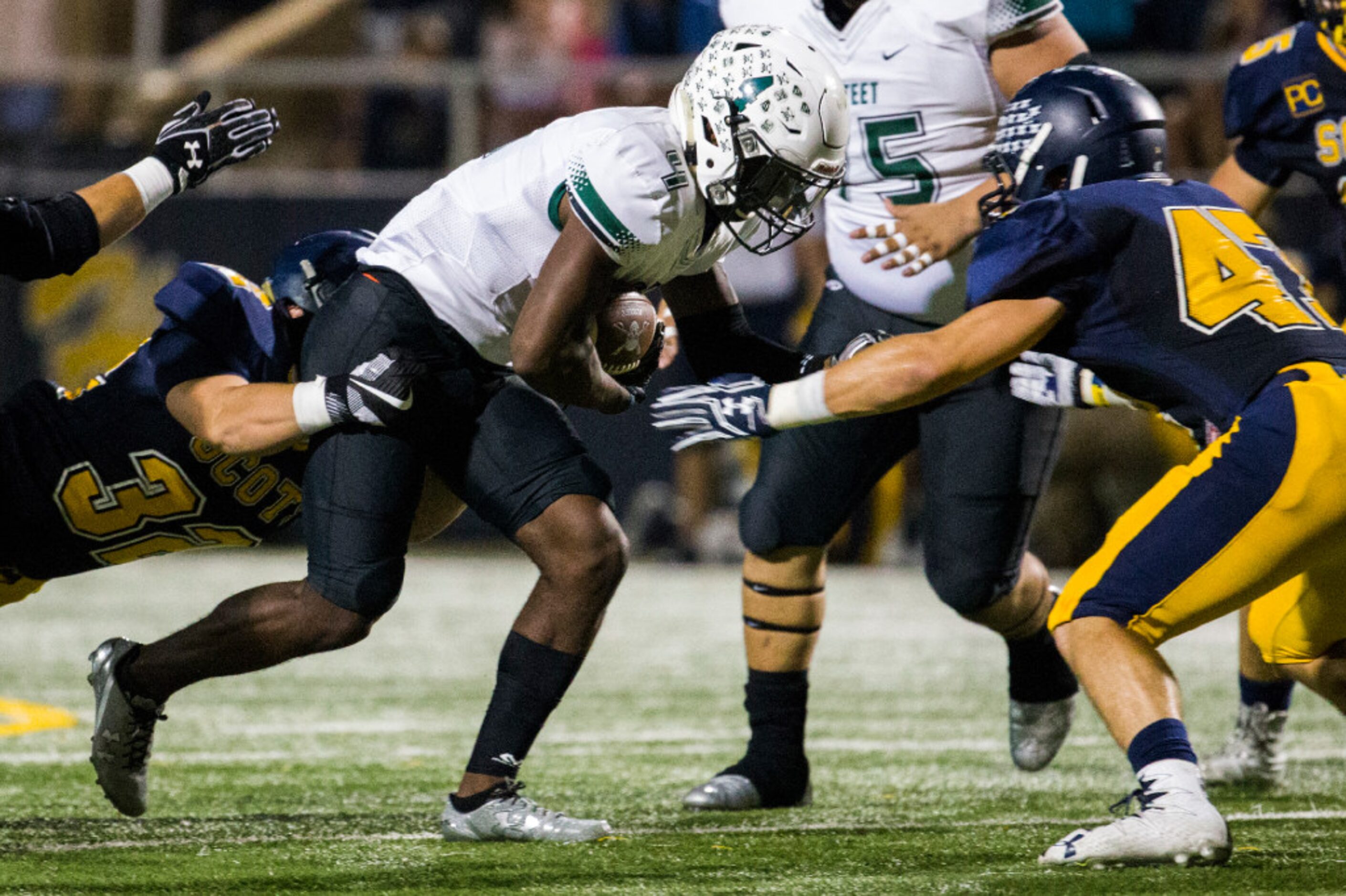 Mesquite Poteet running back Daiquon Jackson (4) is tackled by Highland Park nose guard Tres...