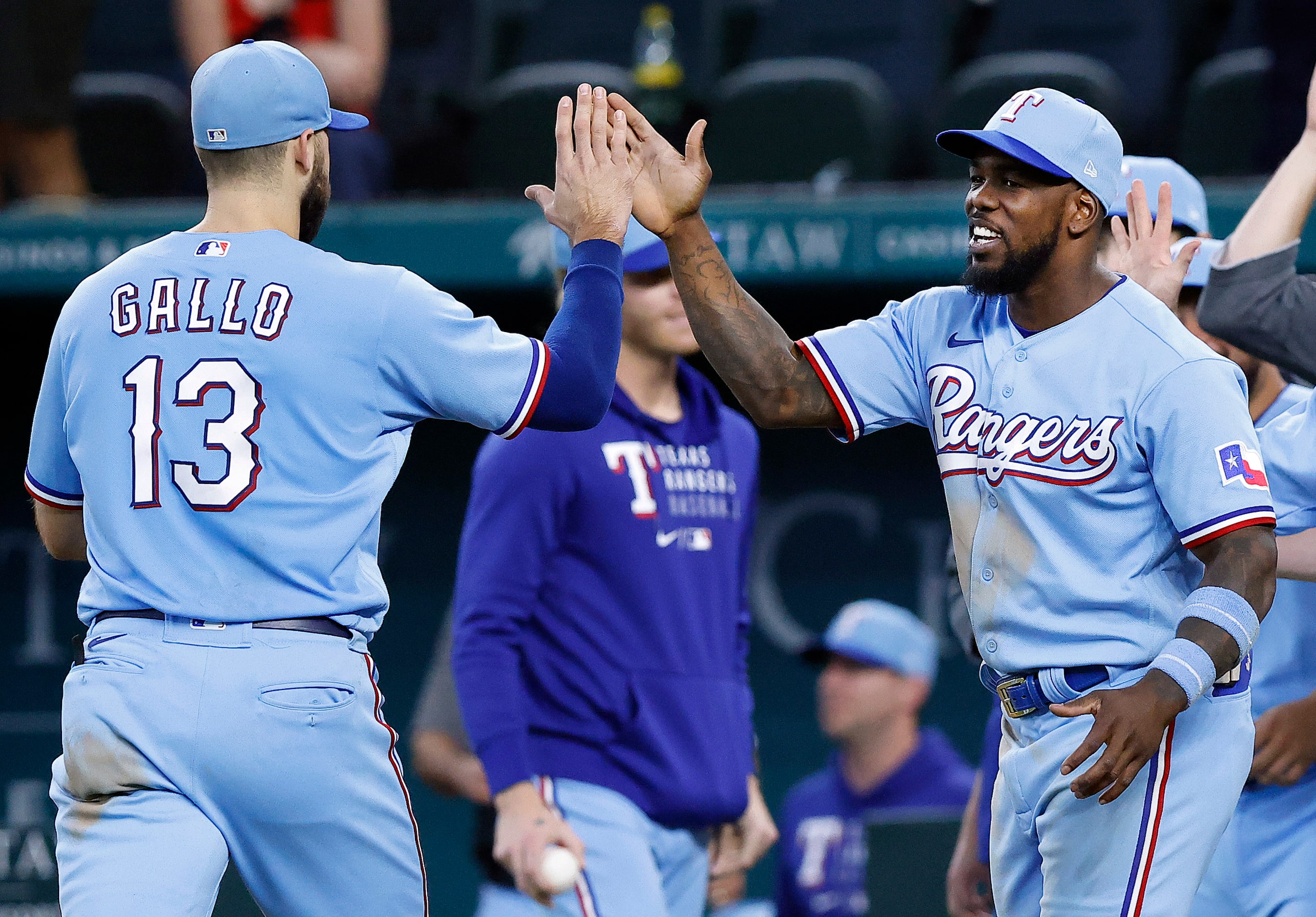 Texas Rangers right fielder Adolis Garcia (right) congratulates Joey Gallo (13) after their...