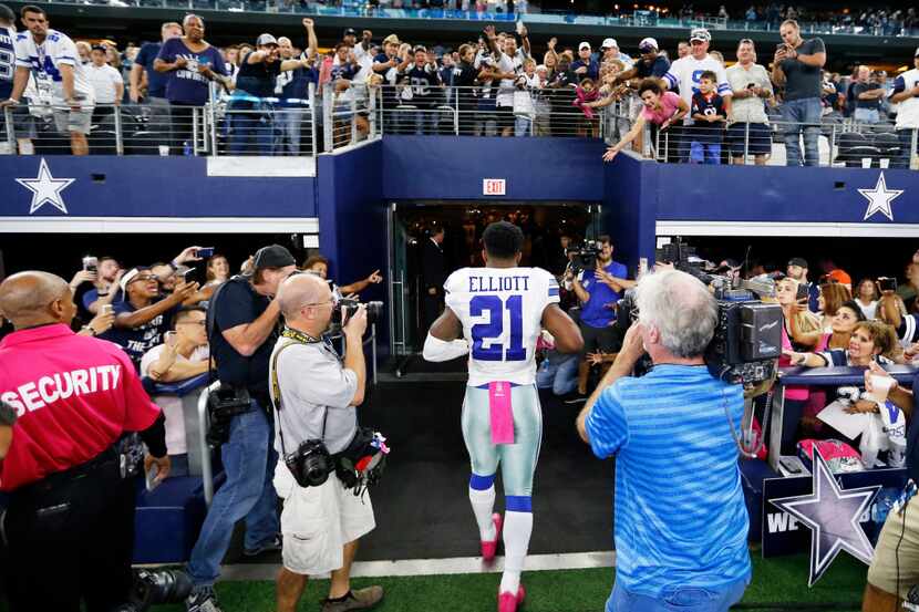 Dallas Cowboys fans cheer on Dallas Cowboys running back Ezekiel Elliott (21) as he exits...