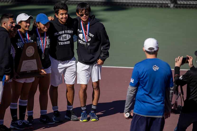 This file photo shows Plano West teammates taking a picture with the runner-up trophy after...
