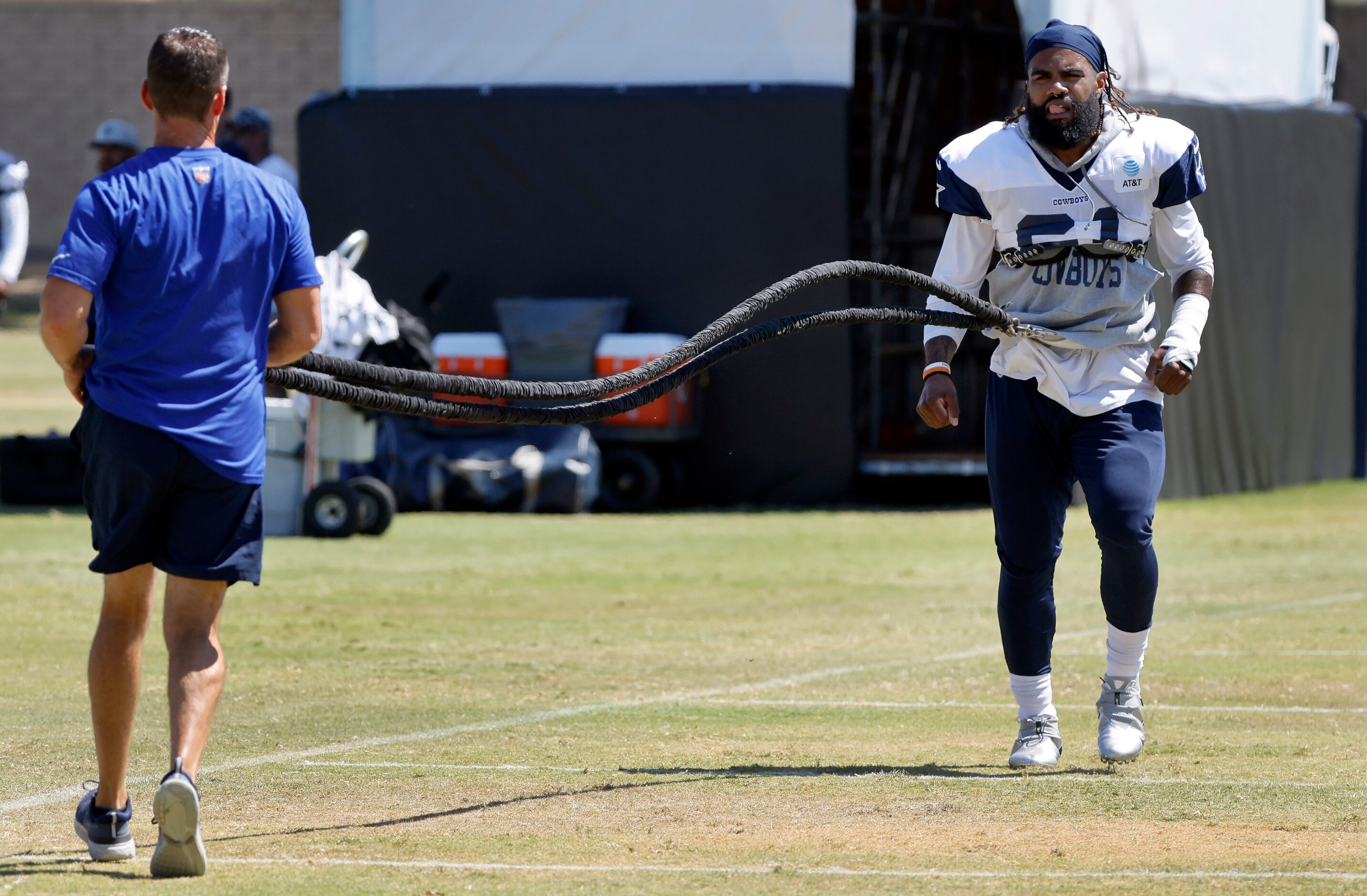 Dallas Cowboys running back Ezekiel Elliott (21) works with athletic trainer Britt Brown on...