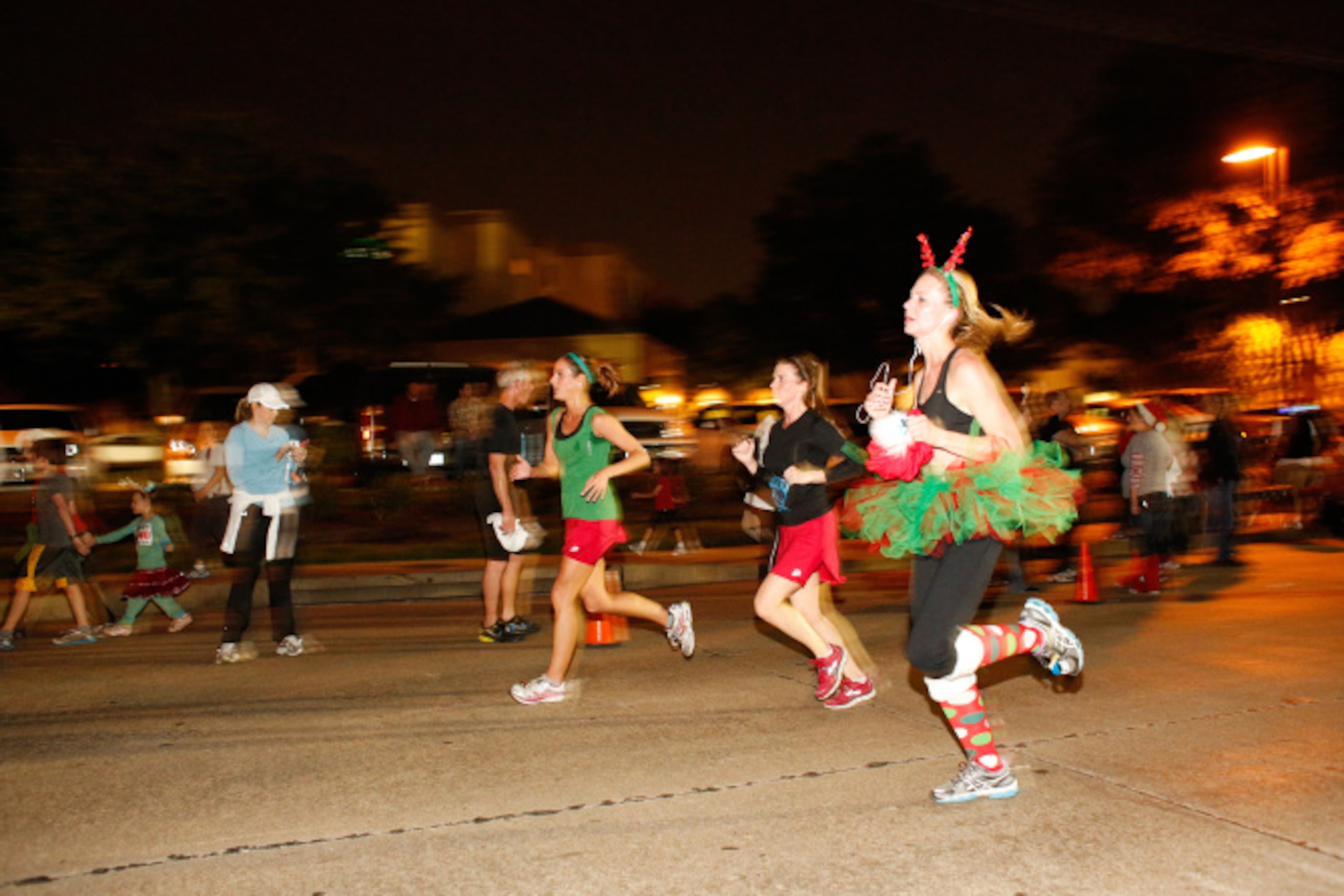 Thousands of runners take the streets for the Jingle Bell Run outside the Hilton Anatole in...