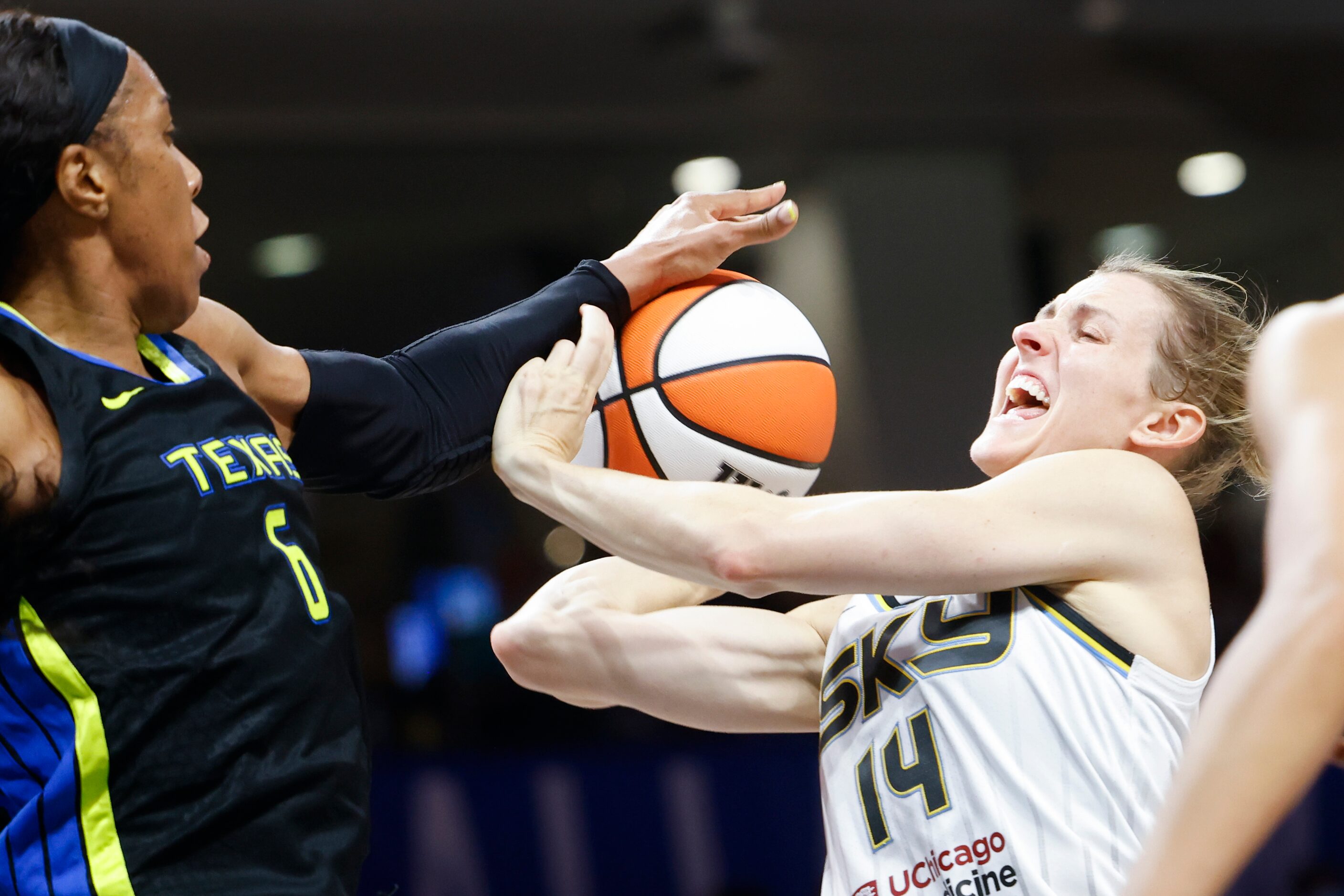 Chicago Sky guard Allie Quigley (14) gets blocked by Dallas Wings forward Kayla Thornton...