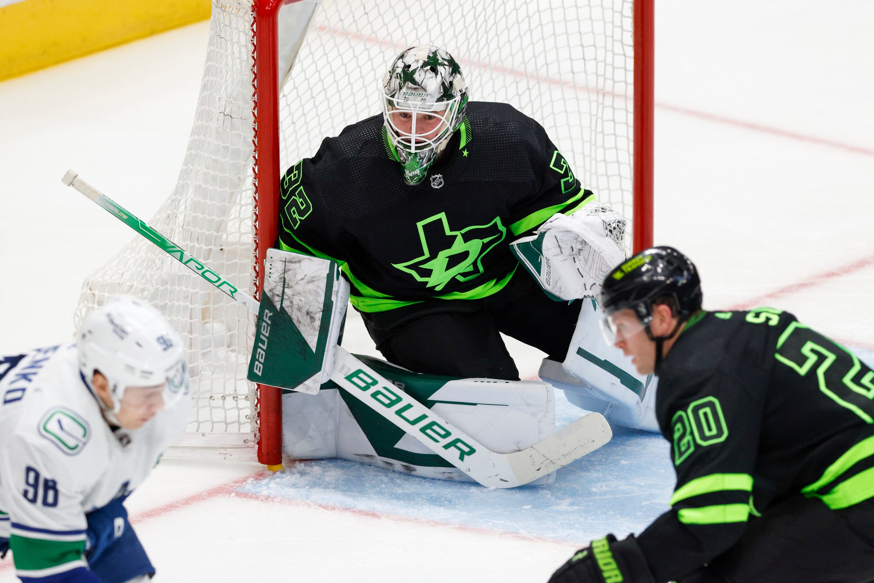 Dallas Stars goaltender Matt Murray (32) watches Vancouver Canucks left wing Andrei Kuzmenko...