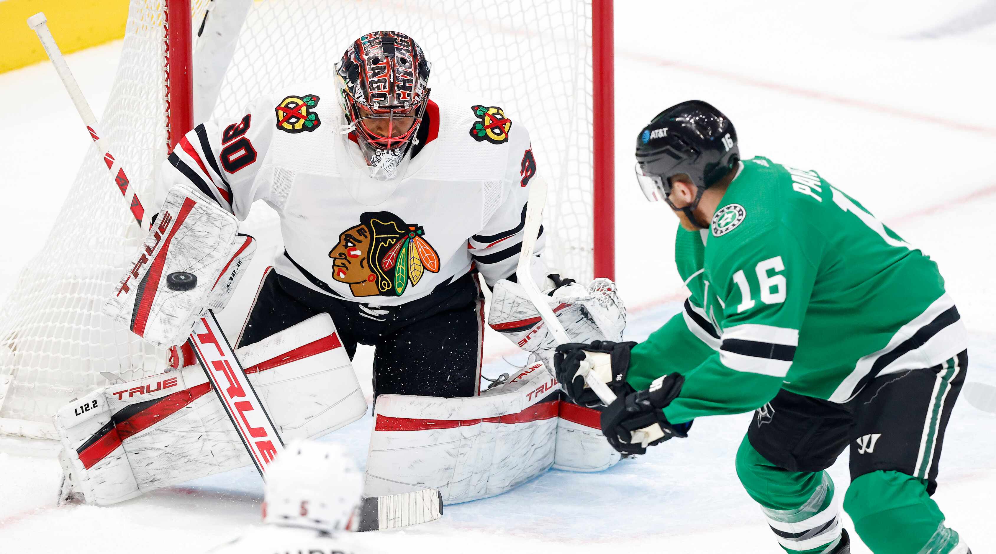 Dallas Stars center Joe Pavelski (16 backhands a shot which is blocked by Chicago Blackhawks...