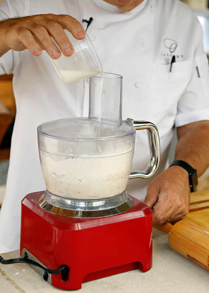 Chef Ken Rathbun pours buttermilk into a food processor as he makes ancho chili-lime...