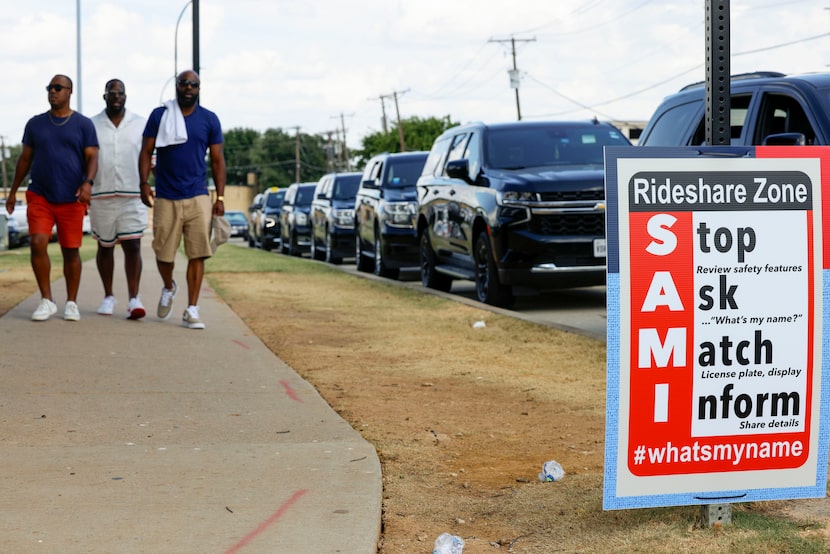 People walk past the rideshare zone outside Globe Life Field during MLB All-Star Weekend,...