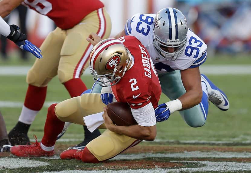 Dallas Cowboys defensive end Ben Gardner (93) tackles San Francisco 49ers quarterback Blaine...