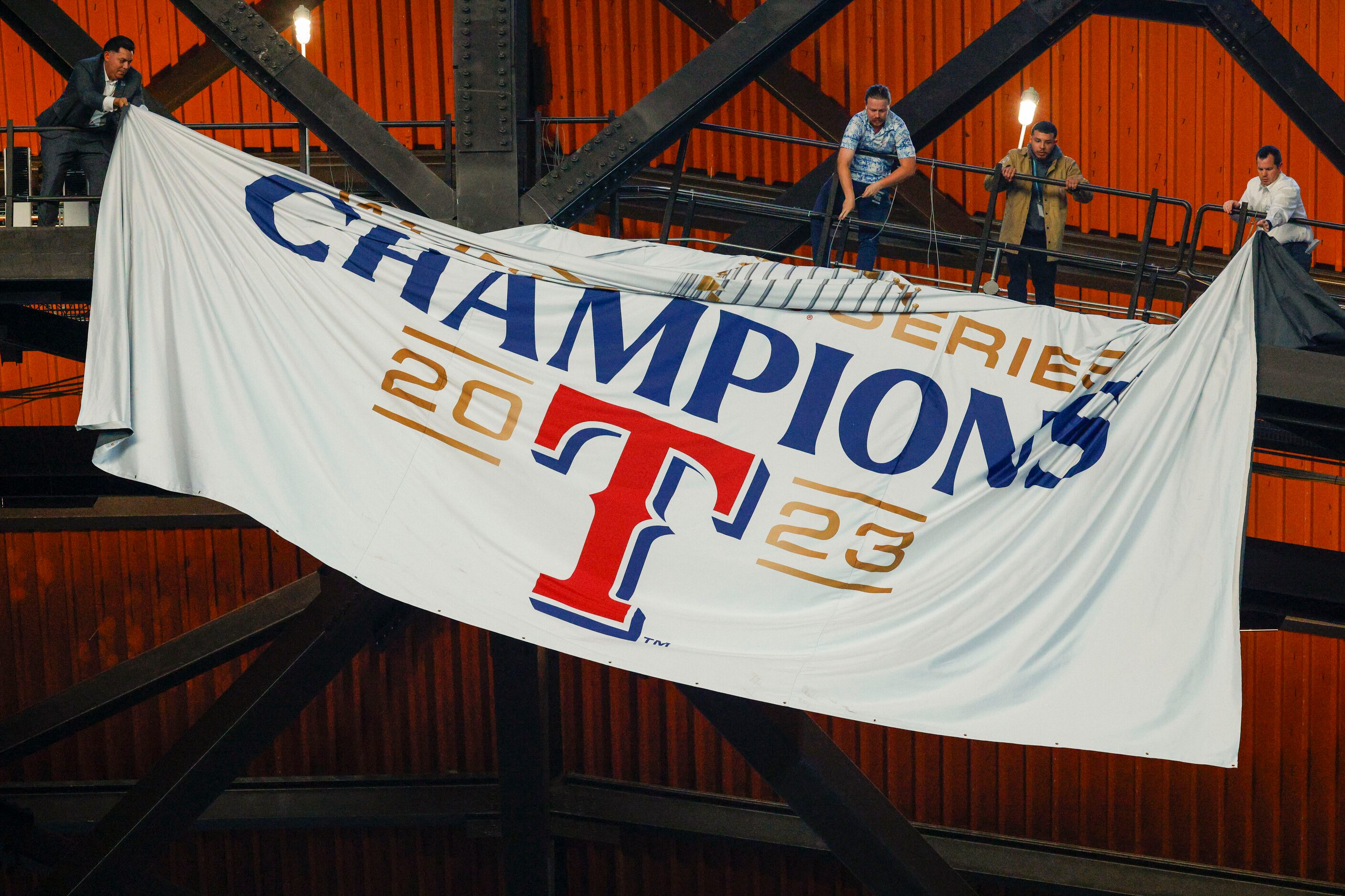 The Texas Rangers World Series championship banner is unfurled from the rafters before the...