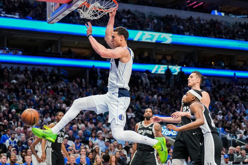 Dallas Mavericks center Dwight Powell (7) dunks the ball past San Antonio Spurs guard Blake...