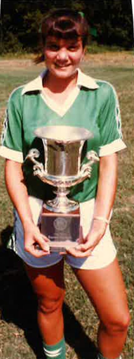 Laura Anton poses with the team's trophy after the D'Feeters Soccer Club won a regional...