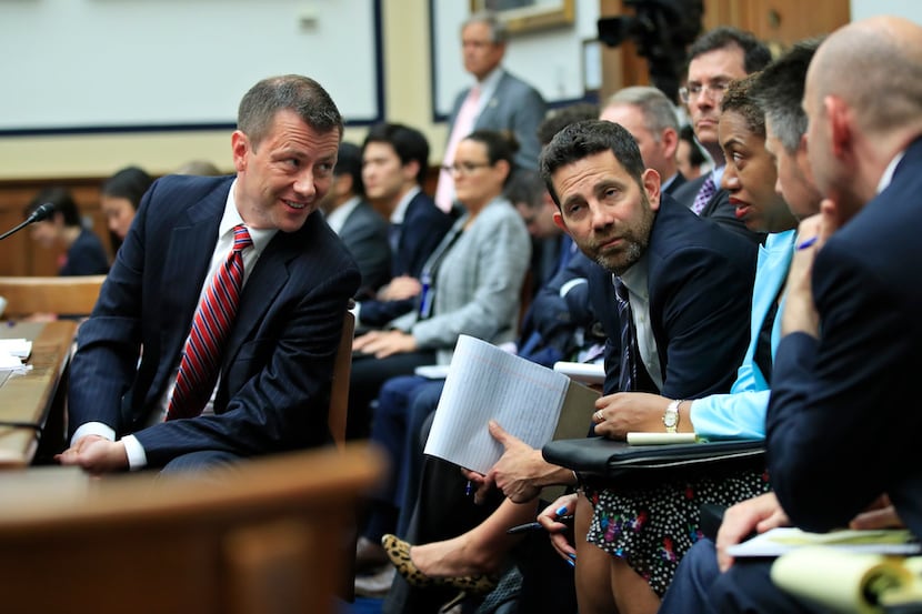 FBI Deputy Assistant Director Peter Strzok (left) confers with his legs team during a House...