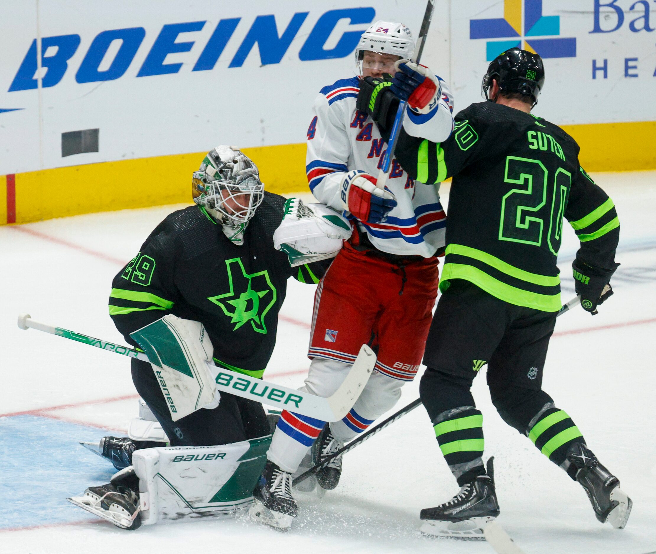 Dallas Stars goaltender Jake Oettinger (29) collides with New York Rangers right wing Kaapo...