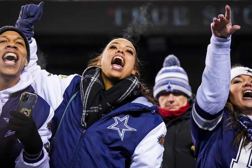 A Dallas Cowboys fans cheer as the teams warm up before an NFL football game against the...