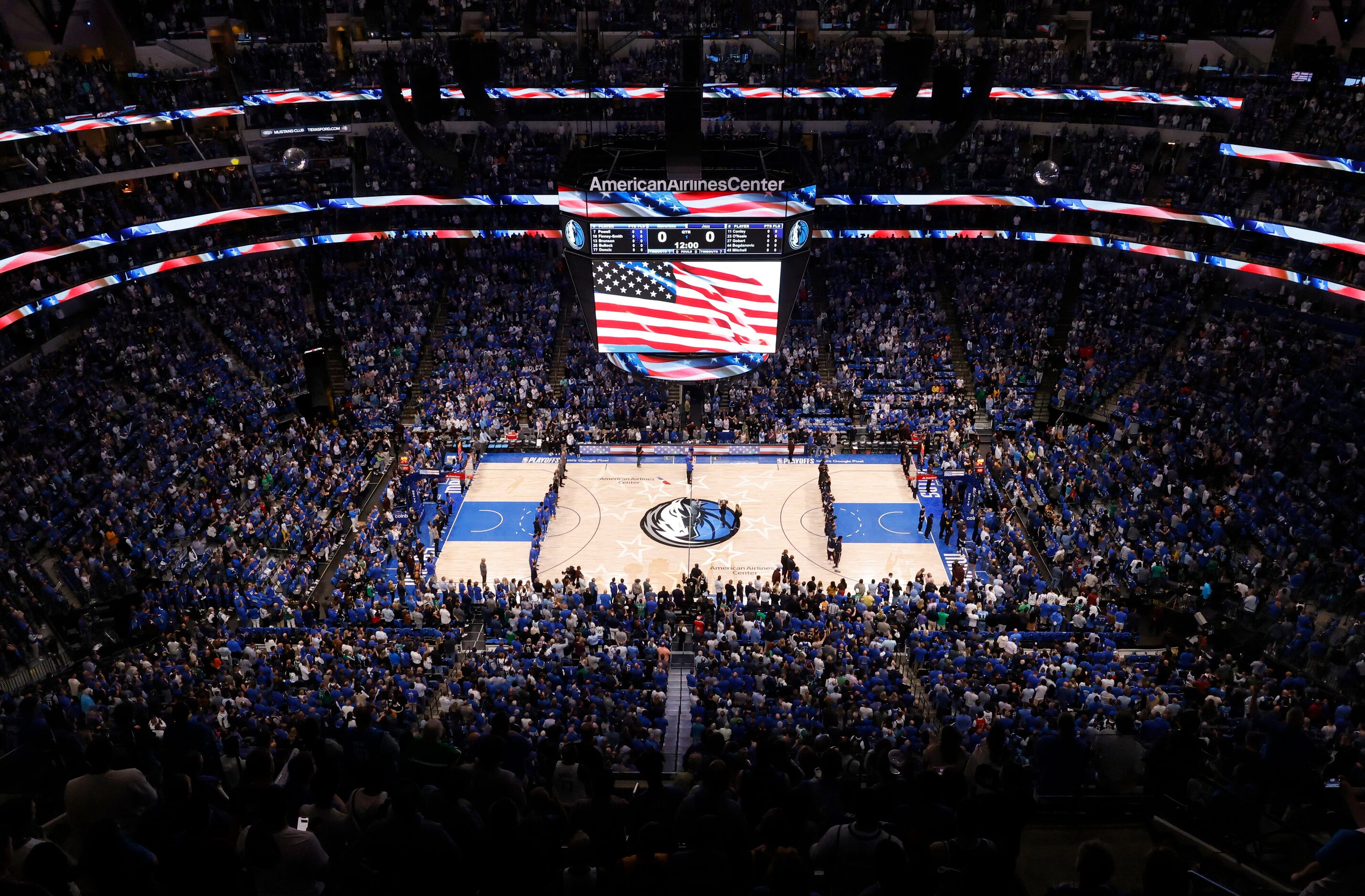 The crowd stands for the national anthem before the Dallas Mavericks faced the Utah Jazz in...