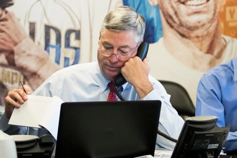 Dallas Mavericks Assistant General Manager Keith Grant works in the team's "war room" during...