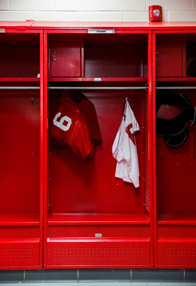 A jersey with the number 6 hangs in the former locker of Dallas Cowboys quarterback Dak...